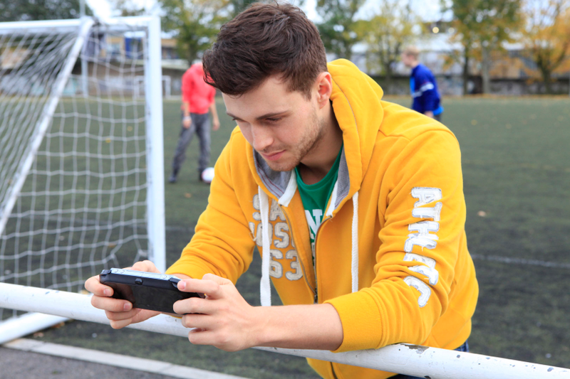 Illustration for article titled Attractive Young Men Smiling at the PlayStation Vita